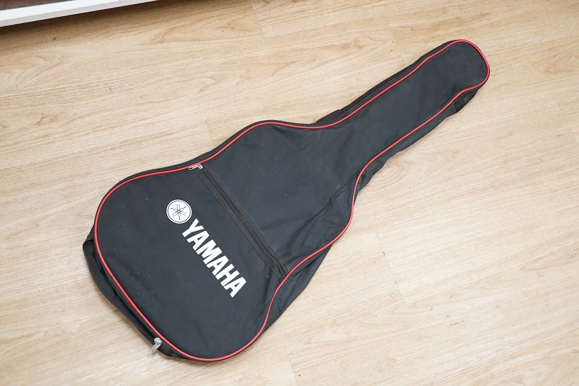 A Yamaha FG700MS acoustic guitar with a soft carry case
